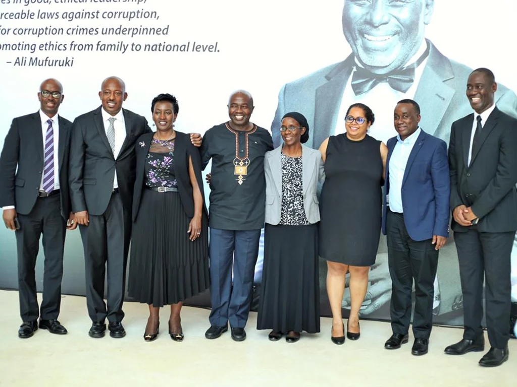 Group photo of ALI-East Africa board members standing together in formal attire beside a backdrop featuring an Ali Mufuruki quote.